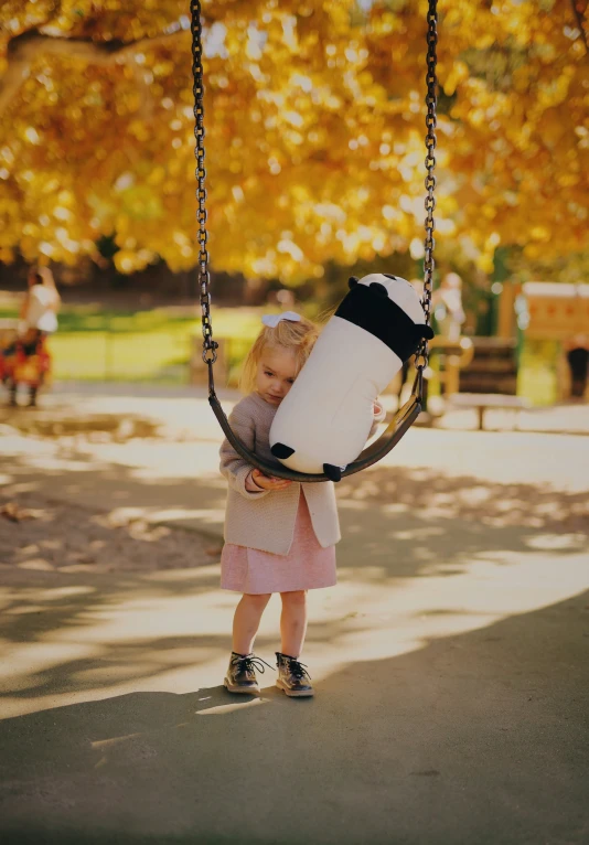 the  is holding a big object in the playground