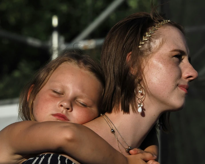 an older lady that is holding a younger girl