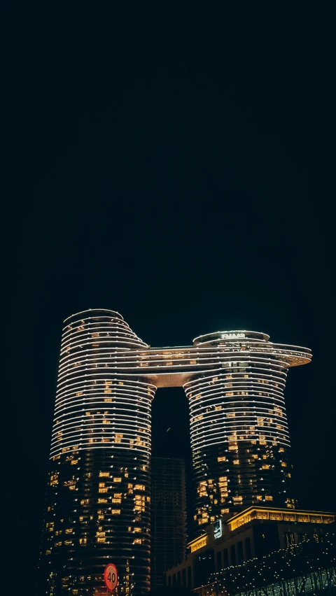 the very large buildings are lit up in the dark