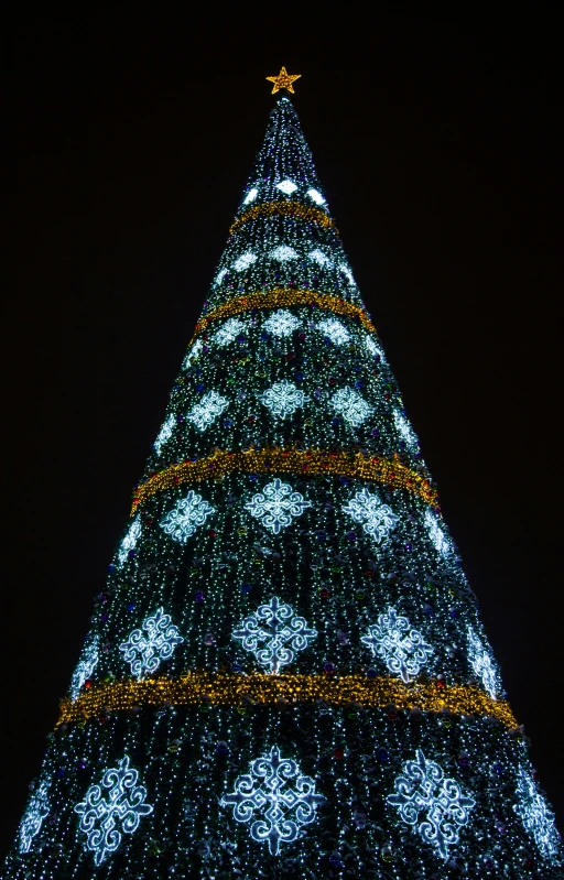 a large lighted christmas tree lit up at night