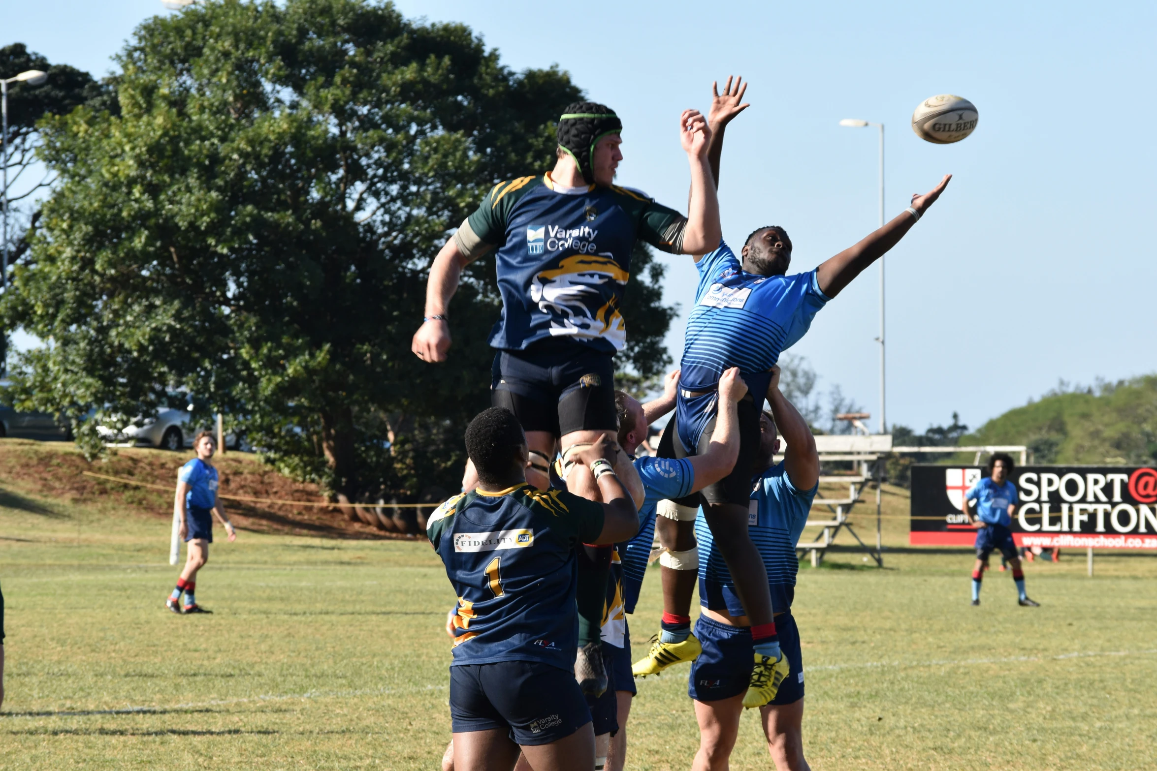 a group of men are playing in a field with a frisbee