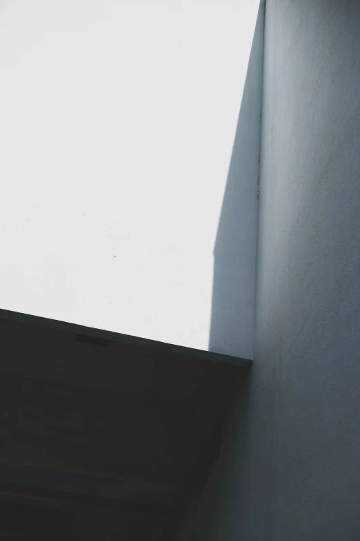 the wall of a building is white with shadows