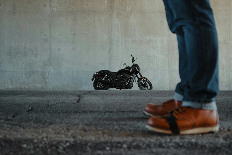 a person is standing next to a parked motorcycle