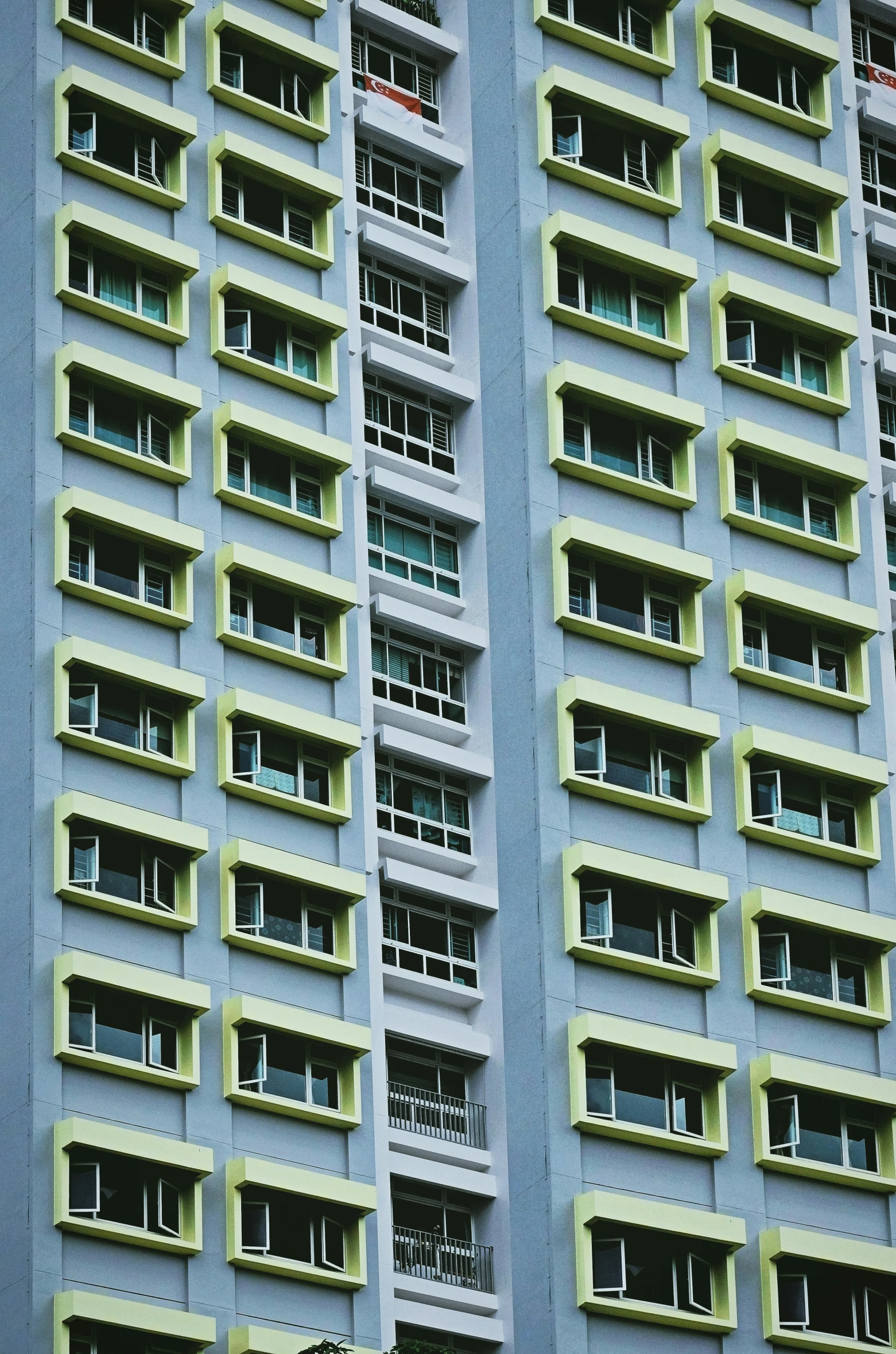 two tall, narrow building windows filled with balconies