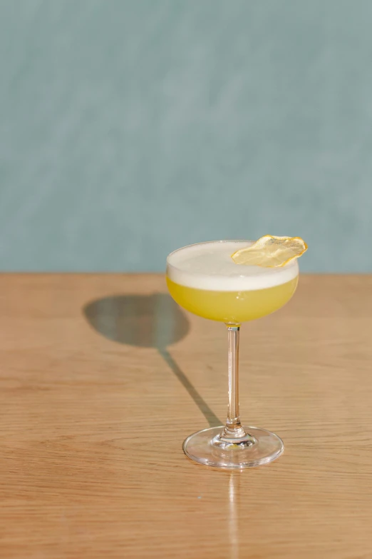 a lemon filled glass with an alcoholic beverage