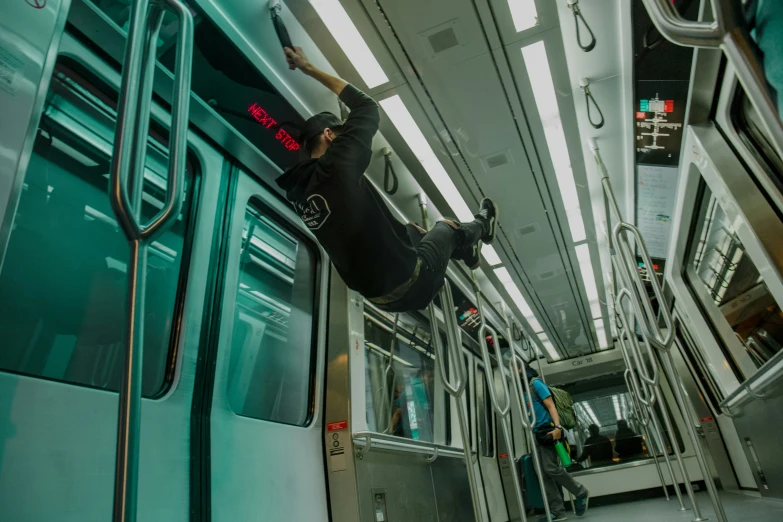 a man riding a subway train with his hand on the window