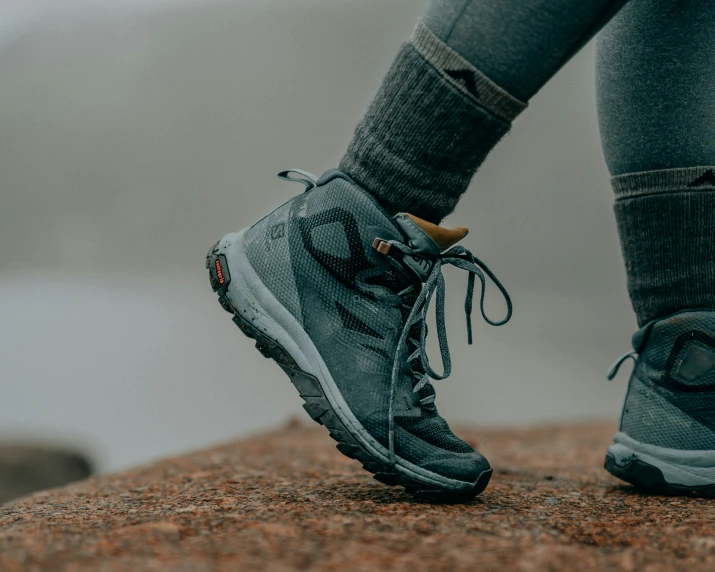 the lower side of a woman's shoe on top of a mountain