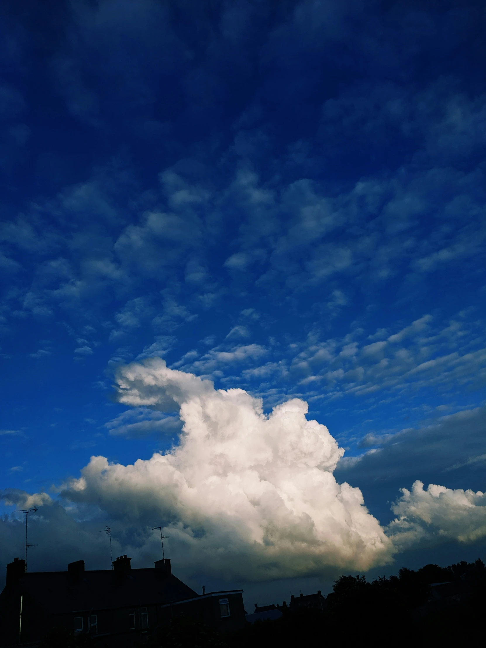 a cloud is seen on a clear blue sky