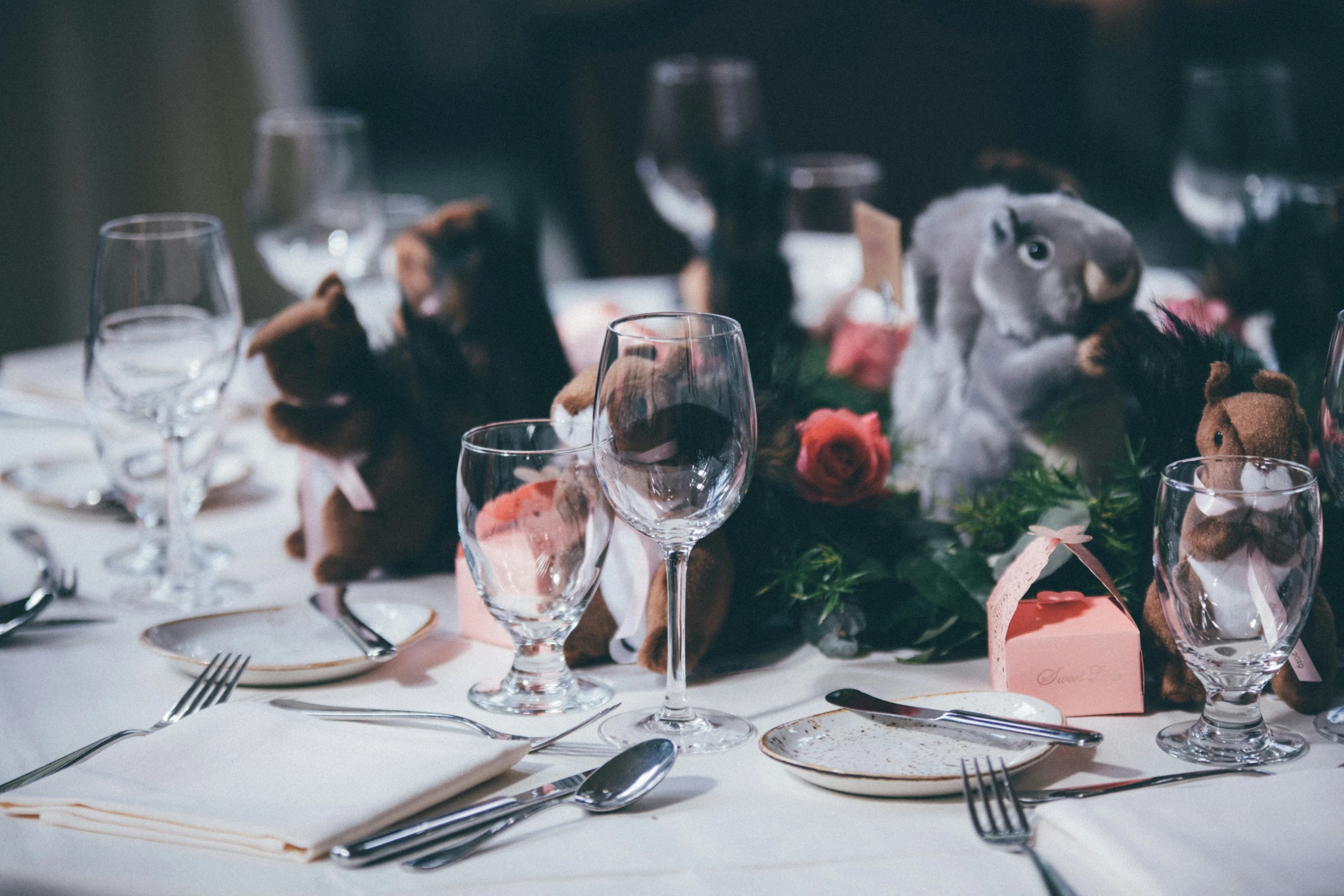 a table is set with many glasses and plates