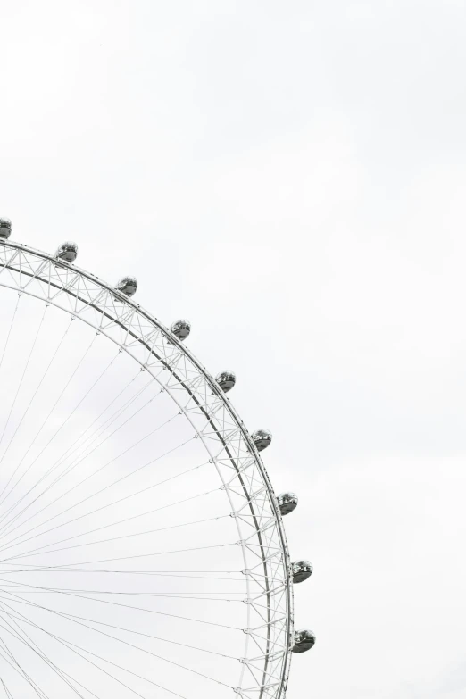 a large, ornate ferris wheel is against a gray sky