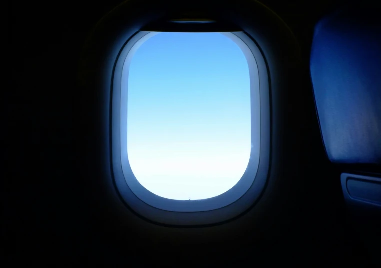 the view out of an airplane window at a cloudless sky