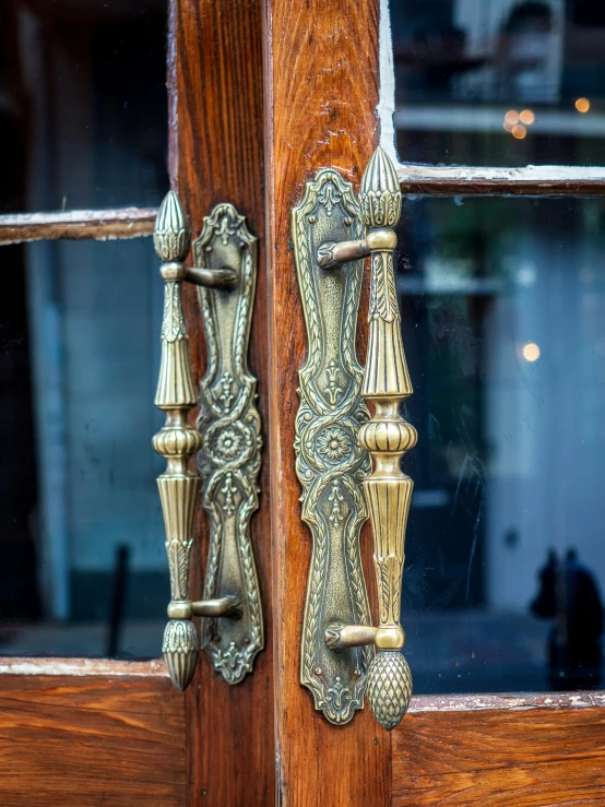 two metal handle latches on wooden door