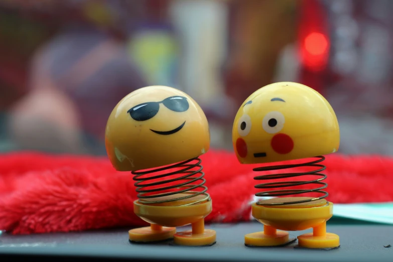 two yellow eggs with faces with a spiral design