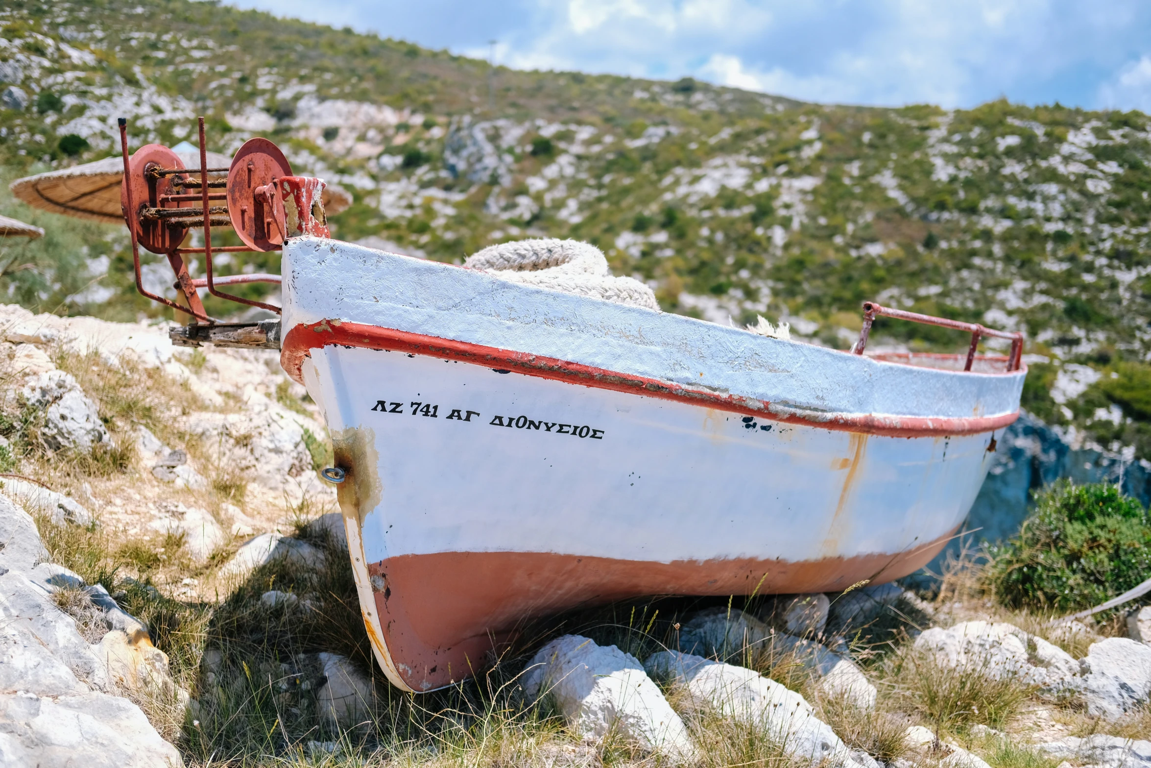 the boat is resting on the rocks outside