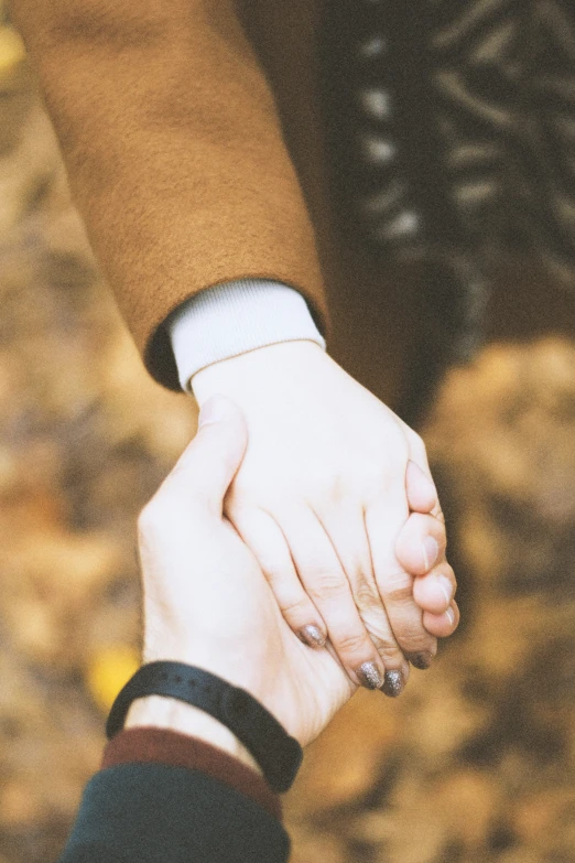 hands hold on top of each other in an emce