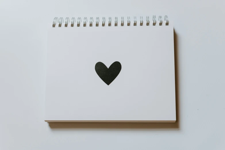 a notepad with a heart painted on it