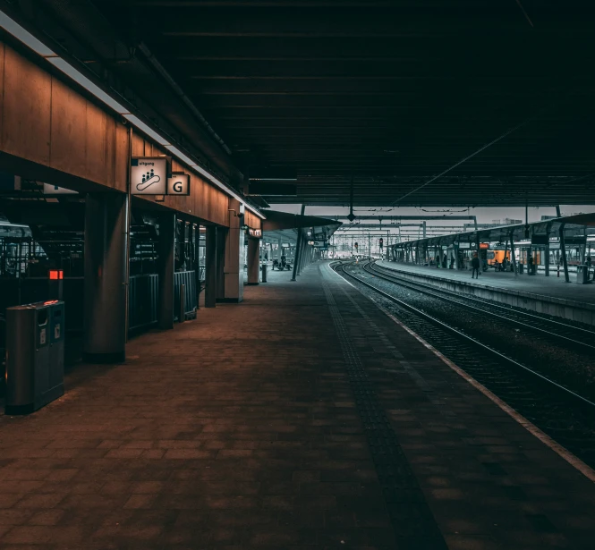 the inside of a train station next to a loading platform