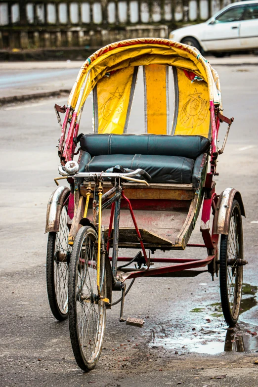 an old time - era rickshaw rides through the street