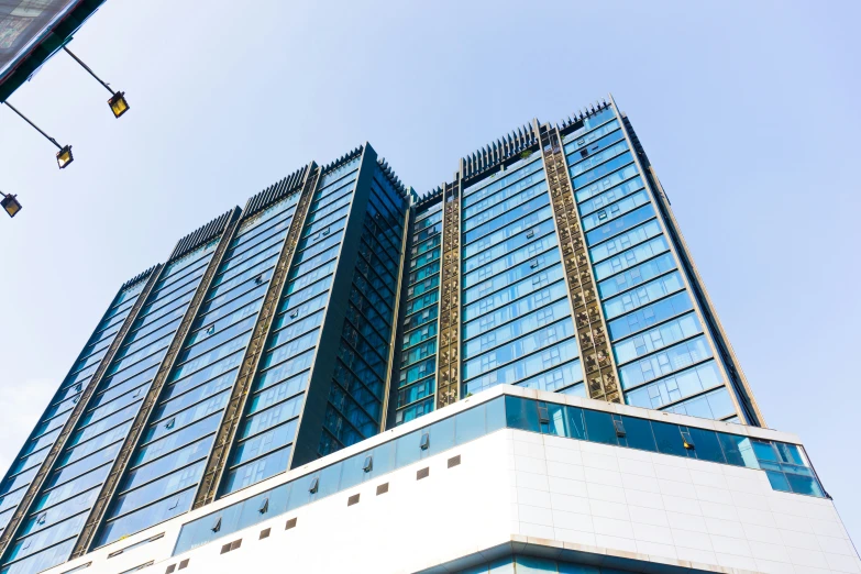 a tall glass building with a lot of windows and one of it's sides slightly open