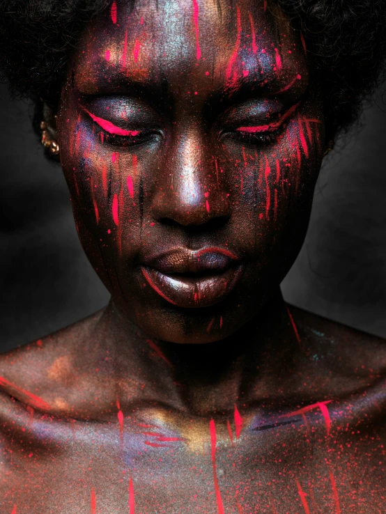 a woman with a black body and red paint all over her face