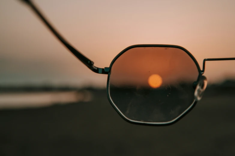 a pair of sunglasses reflected in the side view mirror