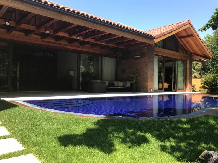 a pool is shown inside the front yard of a house