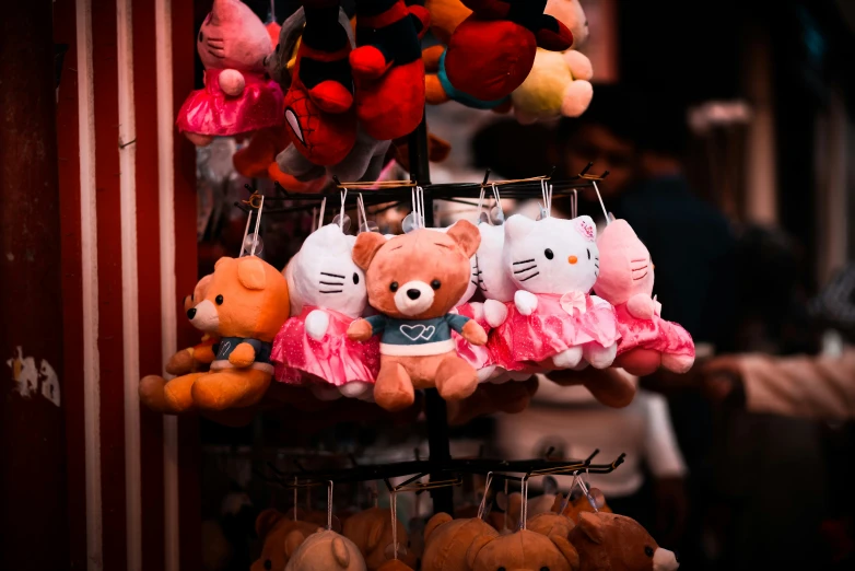 various stuffed animals are displayed for sale in a market