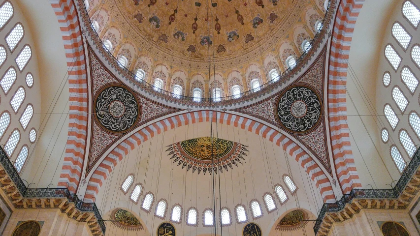 the interior of a dome structure with white and orange tiles