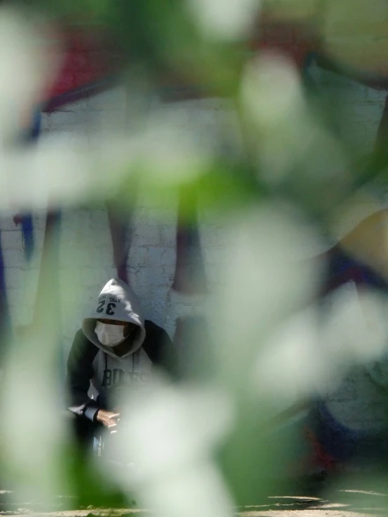 a man is sitting on the bench with a hat on