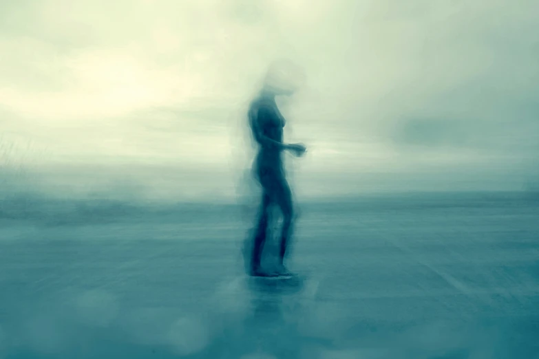 blurry po of man riding skateboard in dark area