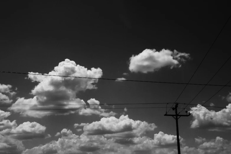 some power lines on a cloudy day above clouds