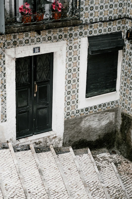 there are steps and plants in front of a building