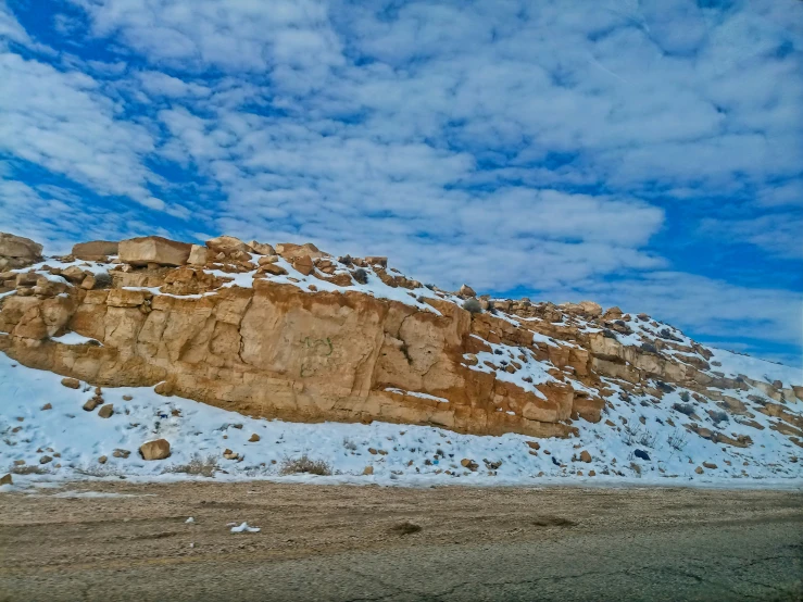 a large rock formation in the snow