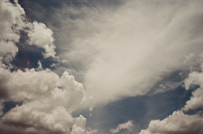 a group of clouds in the sky against a gray sky