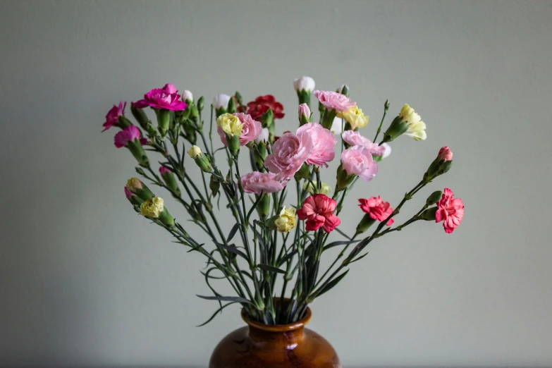 a vase full of different colored flowers