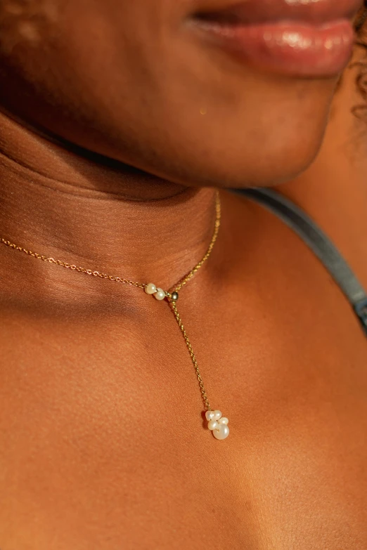 a woman's chest wearing a pearl necklace