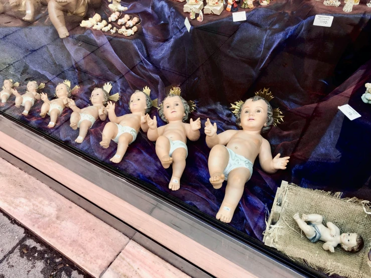 several mannequin dolls are sitting on a display