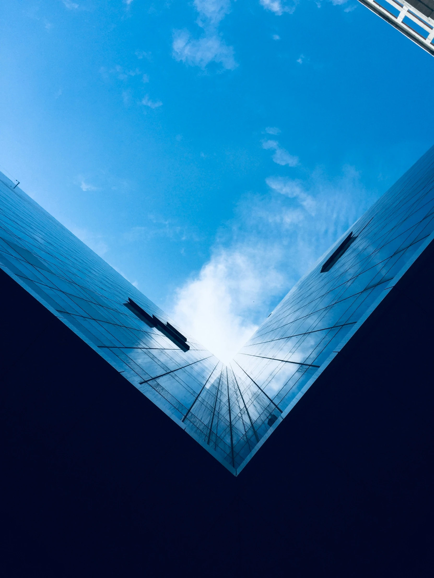 blue glass and steel skyscrs rise into the sky