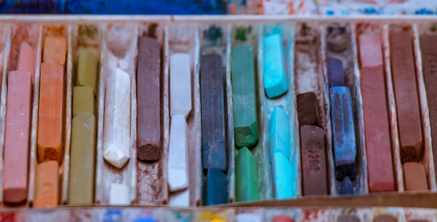 close up of many colors of paint in a box