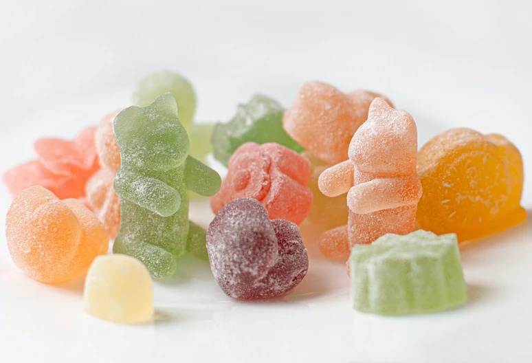 gummy bears all lined up on a white table