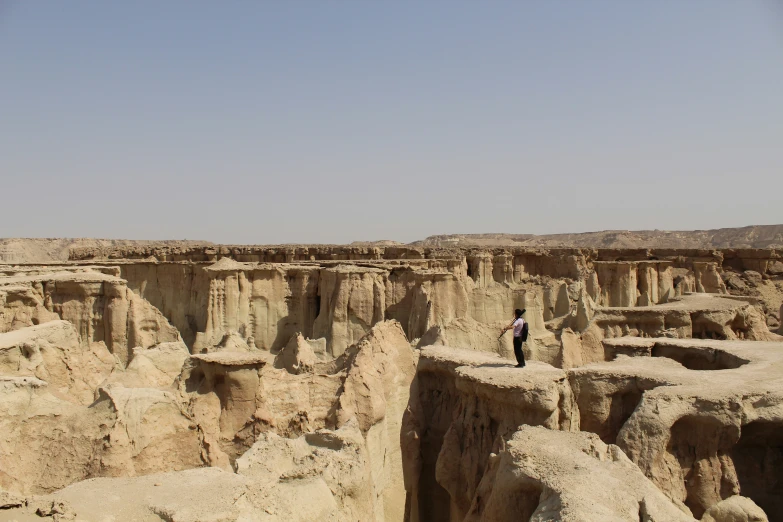 a person in a canyon in the middle of nowhere