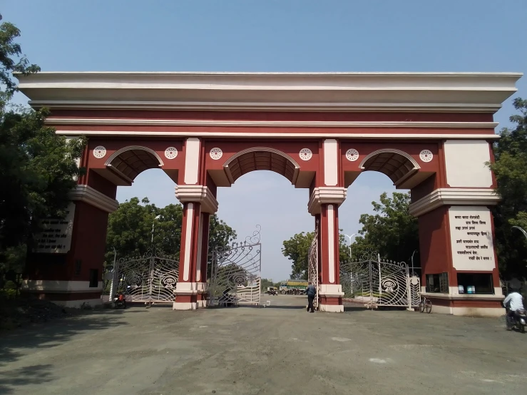 a large red arch covered in statues and carvings