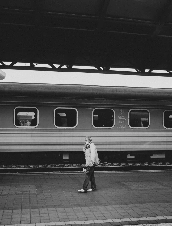 a man is walking down the train tracks