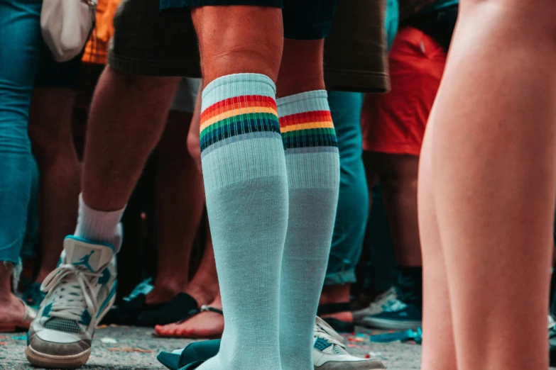 a man's socks with a rainbow colored sock on