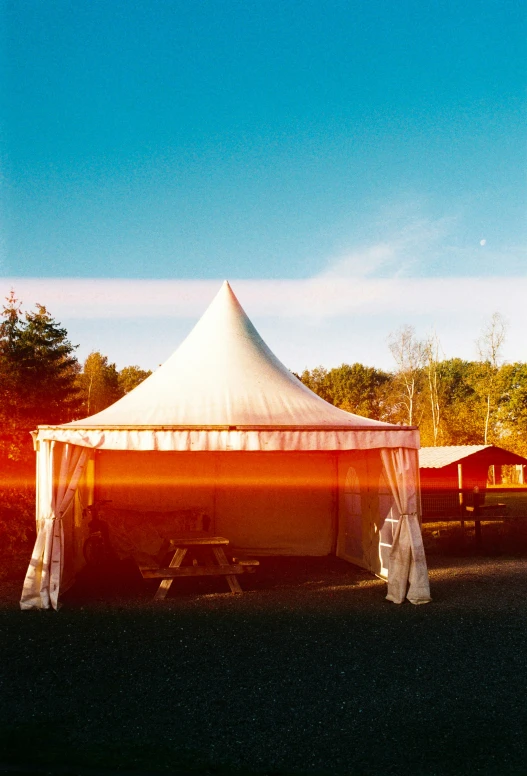 the large tent in the grassy area is ready for people to arrive