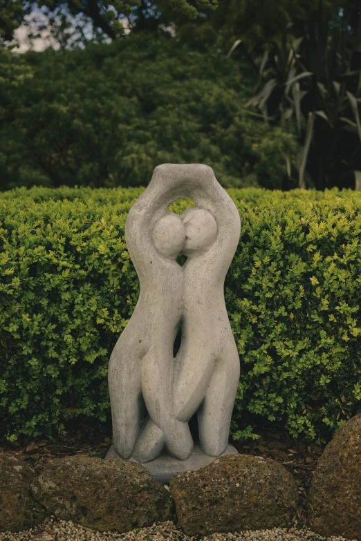 sculpture of two women hugging each other