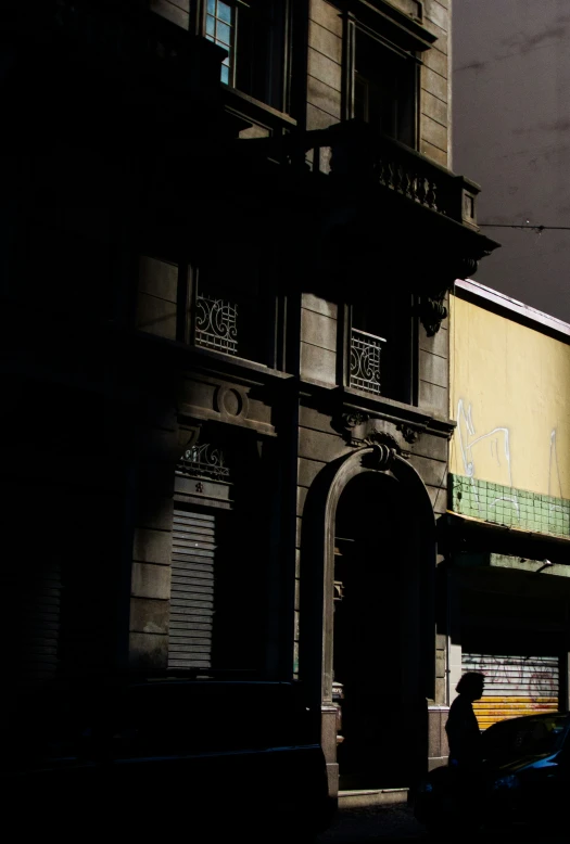 there is a tall yellow building with a clock tower on the corner