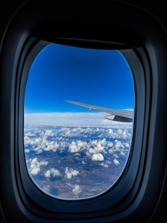 view of the wing of a plane out the window