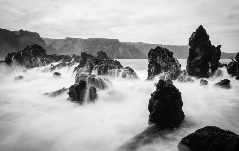 the rocky shore with lots of water coming out of it