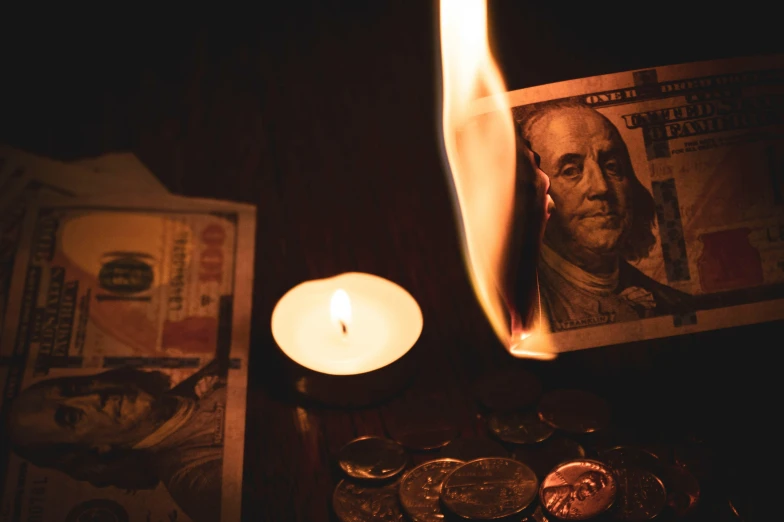 candles sitting next to money on a table